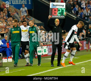 sports, football, Bundesliga, 2017/2018, FC Schalke 04 vs Borussia Moenchengladbach 1:1, Veltins Arena Gelsenkirchen, substitution because of injury, f.l.t.r. team doctor Dr. Stefan Porten (MG), injured team captain Lars Stindl (MG) leaves the pitch, physiotherapist Dirk Mueller (MG), fourth official Mike Pickel presenting the substitution on a message board, substituted Michael Cuisance (MG) Stock Photo