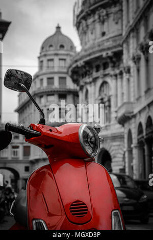 Beautiful red motorcycle scooter in focus and the city in black and white background Stock Photo