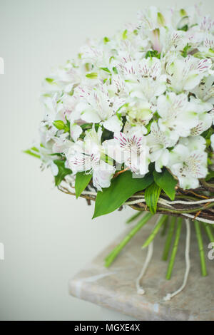 White Lily of the Incas in a bunch on rustic background with copyspace Stock Photo