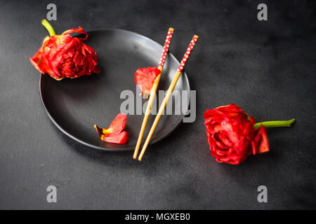 Summer table setting decorated with Red Princess tulips on rustic background Stock Photo