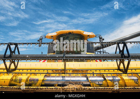 very close view of modern combine harvester in action. Stock Photo