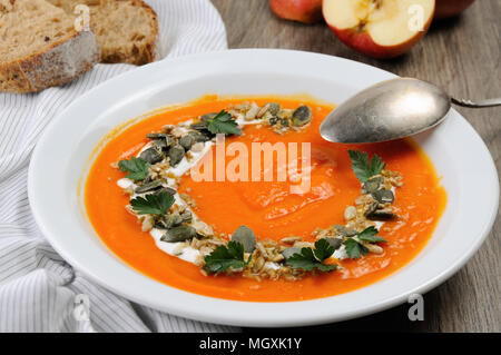 A wipe of pumpkin-apple soup with a tender, soft consistence,  yoghurt  and seasoned with pumpkin seeds and sunflower seeds. This is what you need for Stock Photo