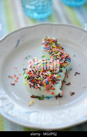 Rabbit-shaped blancmange with sprinkles on a plate Stock Photo