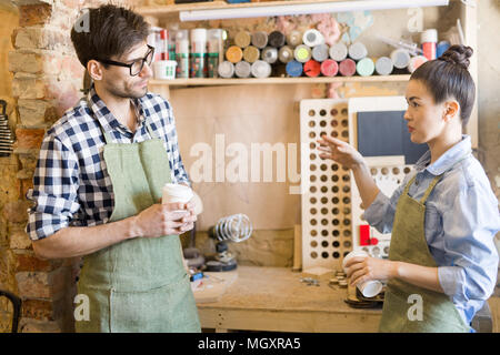 Two Artisans Taking Break from Work Stock Photo