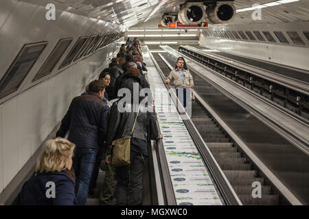 BUDAPEST, HUNGARY - APRIL 7, 2018: People going up from a metro station of Budapest on an escalator at rush hours, empty stairs can be seen on the rig Stock Photo