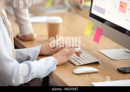 Older woman hands typing on keyboard working on computer, closeu Stock Photo