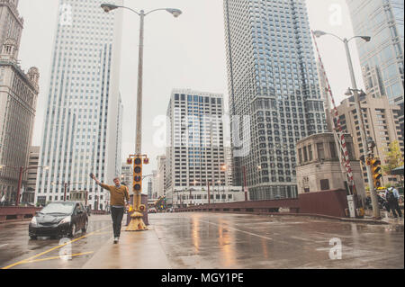 Man walking down the street in large city on a rainy day Stock Photo