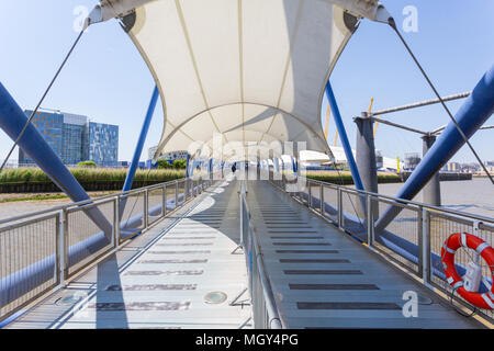 London, United Kingdom - June 11, 2015: A white canopy protects boarding and departing passengers from the Thames Clipper on the River Thames. Stock Photo