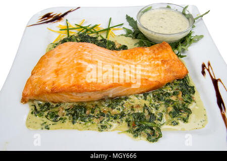 Salmon fillet with spinach and walnut sauce. Stock Photo