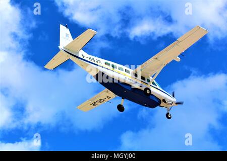 A St Barth Commuter plane coming in to land at Princess Juliana International Airport, Sint Maarten. Shot was taken from Maho beach below in Feb 2018. Stock Photo