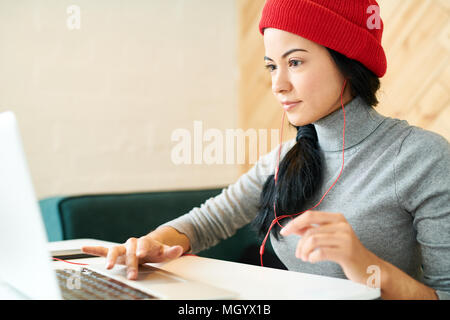 Young Woman Working in Cafe
