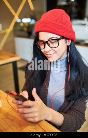 Trendy Young Woman using Smartphone Stock Photo