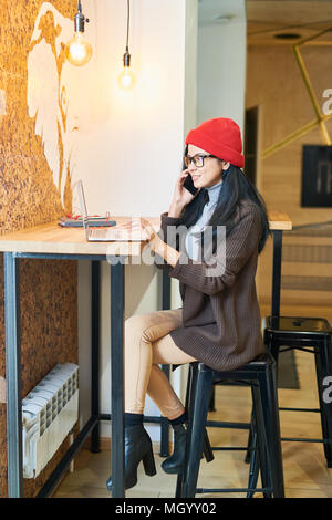 Contemporary Woman Working in Cafe