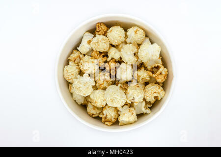 Top view of caramel popcorn in cup on white background Stock Photo