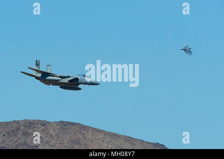 Formation Of Two F-15C Eagle Jet Fighters Of The California Air National Guard, 144th Fighter Wing, Diving Into Rainbow Canyon, California, USA. Stock Photo