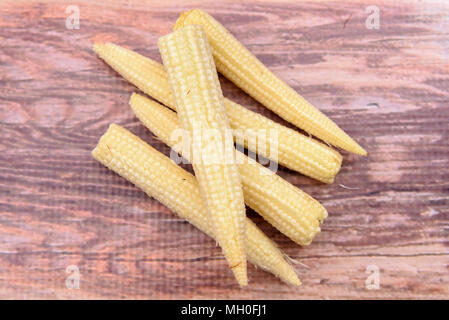 Baby Sweetcorn on a wooden background Stock Photo