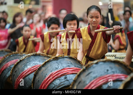 Teenagers performing chinese lion dance drum rhythmic show and dance at VIVA HOME shopping mall in Kuala Lumpur, Malaysia. Stock Photo