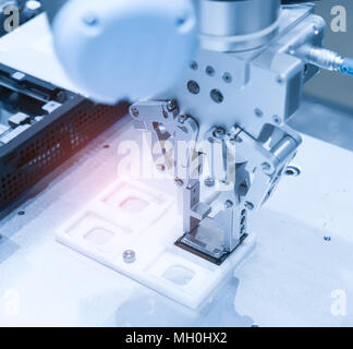 Robotic arm installing a computer chip Stock Photo