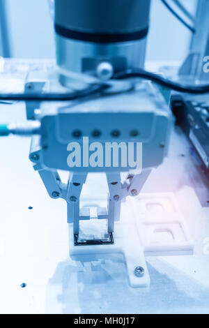 Robotic arm installing a computer chip Stock Photo