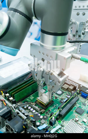 Robotic arm installing a computer chip Stock Photo