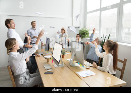 Multiracial team of young and senior people launching paper plan Stock Photo