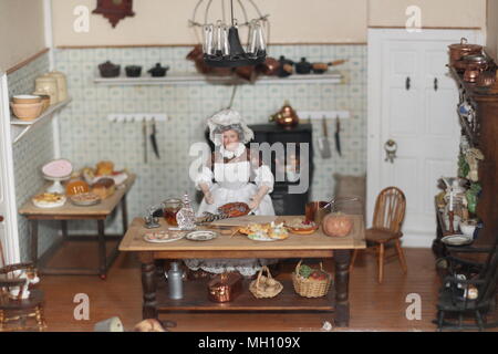 Upstairs, Downstairs - inside a Victorian dolls house & cooks kitchen. Stock Photo