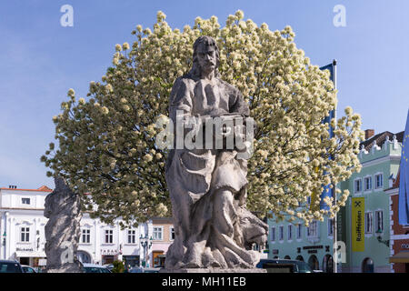 A statue of Mark the Evangelist holding his gospel and a lion, one of four Evangelist statues in Langenlois' main square (Kornplatz), Lower Austria Stock Photo