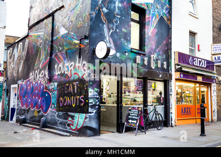 Building covered in street art graffiti, facade of Magna donut shop in Brick Lane, London, UK Stock Photo