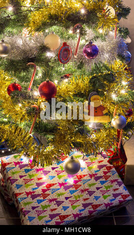 Christmas presents under an artificial Christmas tree Stock Photo