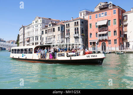 Number 1 vaporetto (waterbus, water bus)  to Lido on the Grand Canal, Venice, Veneto, Italy full of passengers using the public transport
