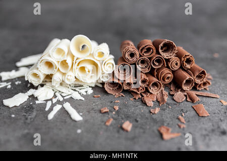 Delicious milk and white chocolate swilrs on rustic background Stock Photo