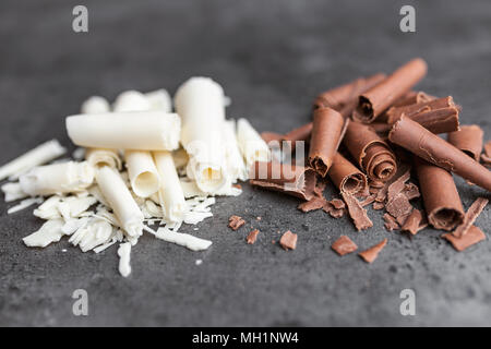 Delicious milk and white chocolate swilrs on rustic background Stock Photo