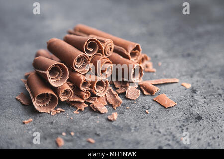 Delicious milk chocolate swilrs on rustic background Stock Photo