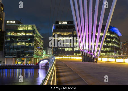 Night view of the MediaCityUk swing bridge leading across to Media City and the BBC office buildings viewed from the south side of the Manchester Ship Stock Photo