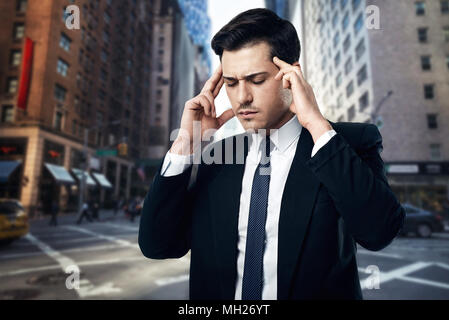 Tense and thoughtful businessman in black suit Stock Photo