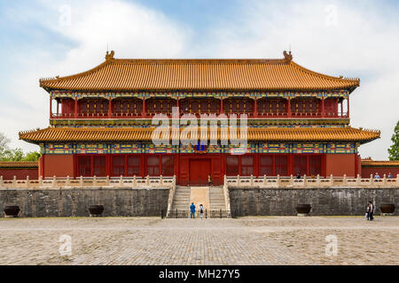 Tourists wonder at The Pavilion of Rigorous Justice with it's elaborate decoration and yellow glazed tile roof. Forbidden City, Beijing, China. Stock Photo