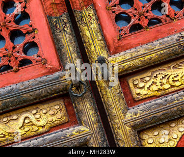 Detail of a pair of intricately decorated gold and red ancient Chinese doors found at the Forbidden City, Beijing, China. Stock Photo