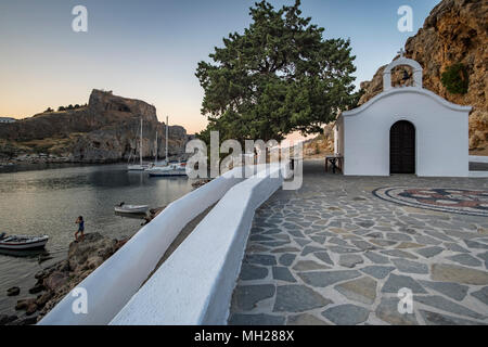 Sunset over St. Pauls Chapel, St Pauls Bay, Lindos, Rhodes Stock Photo