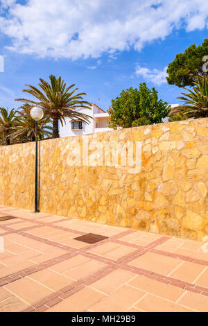 Typical Spanish villa in tropical garden - view from coastal promenade to Cala Gat beach, Majorca island, Spain Stock Photo
