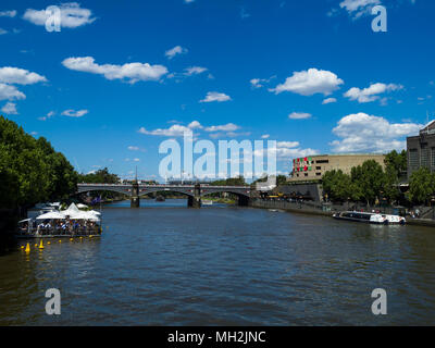 Yarra river with tram crossing Princes Bridge and Melbourne Cricket Ground in the distance, Melbourne, Victoria, Australia. Stock Photo