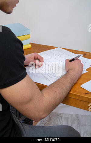 a young man writing, making an argument for a video Stock Photo