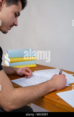 a young man writing, making an argument for a video Stock Photo