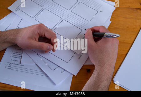 a young man writing, making an argument for a video Stock Photo