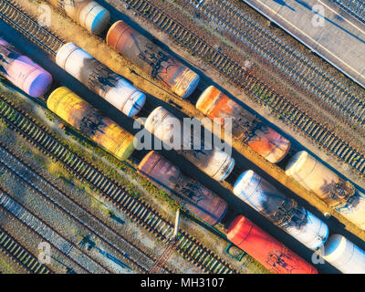 Aerial view of colorful freight trains on the railway station. Cargo trains close-up. Old wagons with goods on railroad. Heavy industry. Industrial co Stock Photo