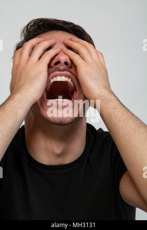 a young man with black tshirt siting down in depression Stock Photo - Alamy