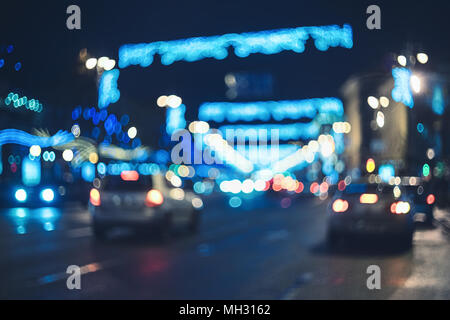 Blurred city at night. Bokeh. Beautiful abstract background with defocused buildings, cars, city lights, people. Colorful bokeh background with urban  Stock Photo