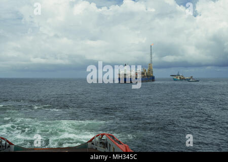 AHTS vessel doing static tow tanker lifting. Ocean tug job Stock Photo