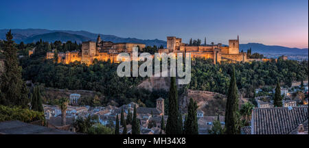 Panoramic view of the Alhambra Palace in Granada, Andalusia Spain at dusk, with the Sierra Nevada mountain range in the background Stock Photo
