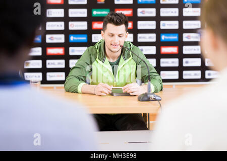 Young Man Talking to Press at Conference Stock Photo