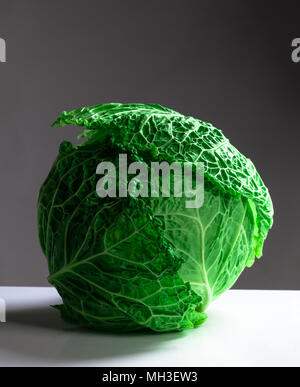 Fresh savoy cabbage isolated on gray background. Stock Photo